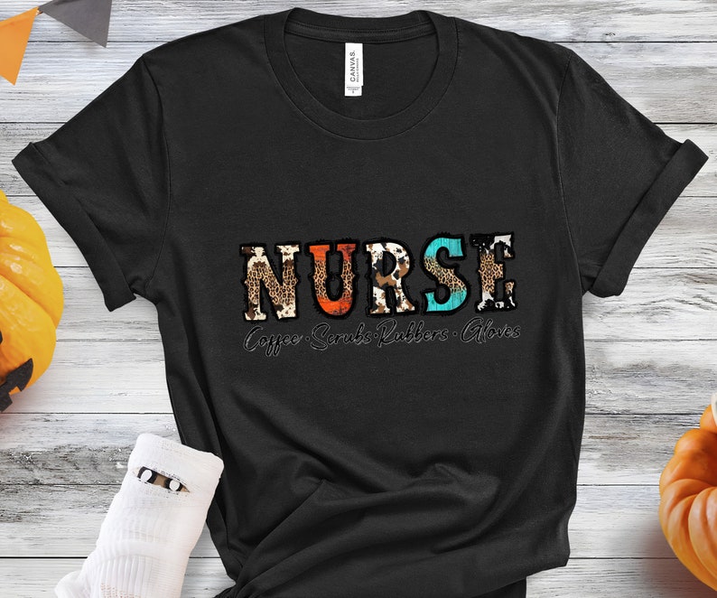 May include: Black t-shirt with the word "NURSE" in colorful patterned letters. The text "Coffee Scrubs Rubbers Gloves" is printed below the word "NURSE".