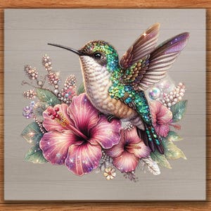 May include: A colorful illustration of a hummingbird perched on pink hibiscus flowers. The bird has iridescent green and blue feathers, with wings spread. The artwork is set against a gray wooden background, with a wooden border.