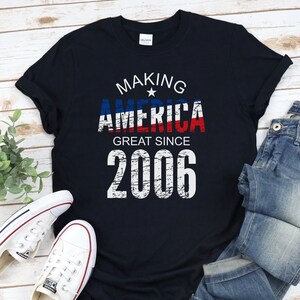 May include: A black t-shirt with a white graphic that says "Making America Great Since 2006". The graphic features a red, white, and blue American flag design with a star.