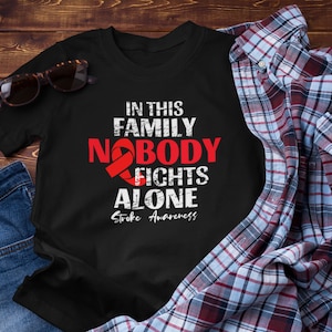 Stroke Cancer Awareness  Unisex T-Shirt: In This Family Nobody Fights Alone, Survivor Fighter Gift For Men and Women, Stroke Awareness Month