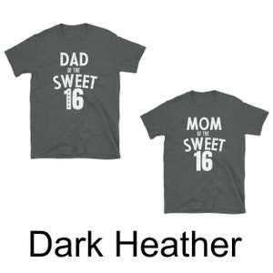 May include: Two dark heather grey t-shirts with white text. The first shirt says "Dad of the Sweet 16". The second shirt says "Mom of the Sweet 16".