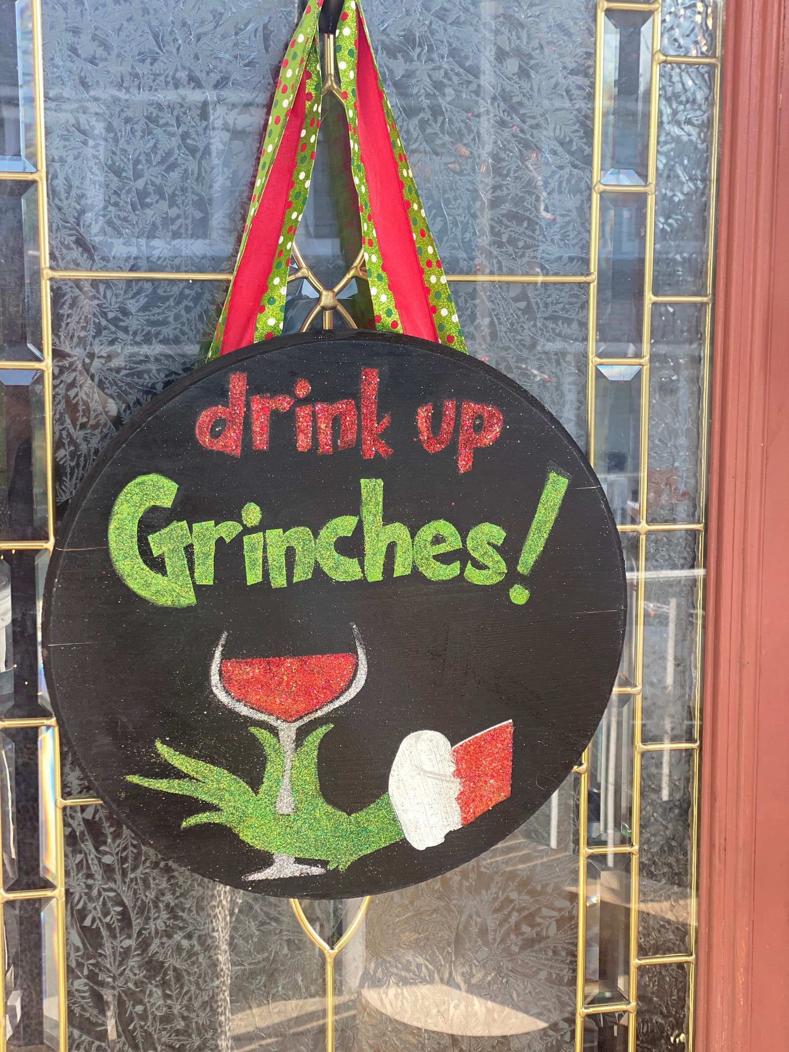 Drink up grinches door hanger made from all glitter but