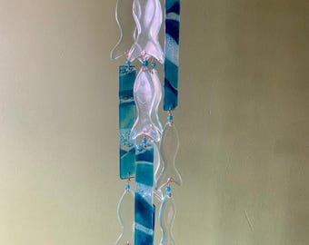 Large Suncatcher windchime, with candle holder. Created using recycled glass. 12 Fishes hung along side sea greens and blues.