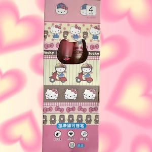 Puede incluir: Una caja rectangular rosa que contiene 4 bol&iacute;grafos, con gr&aacute;ficos de Hello Kitty, lazos y ositos. El empaque muestra el texto 4 PCS, YJ-2093, lucky y 0.5 mm. El dise&ntilde;o incluye ilustraciones de Hello Kitty montando un scooter.