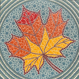 May include: A close-up of a colourful, abstract painting of a maple leaf. The leaf is painted in shades of red, orange, and yellow, and is surrounded by a blue background with white dots. The painting is done in a dot-to-dot style.