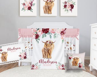 May include: A nursery set featuring a watercolor design with a Highland cow and calf, surrounded by floral arrangements in shades of pink and burgundy. The set includes a crib, bedding, and decorative pillows.
