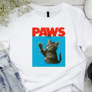 Funny Cat Shirt – PAWS Jaws Parody Tee – Cute Kitten Graphic T-Shirt – Cat Lover Gift – Pun Shirt for Her or Him – DTF Print