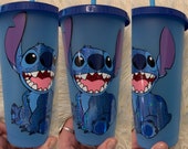 Disney Inspired Stitch made with holographic vinyl on a translucent blue cold cup
