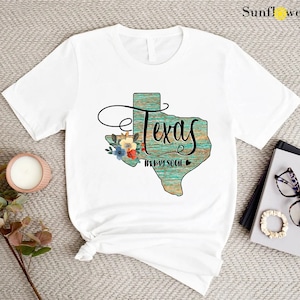 a t - shirt that says texas with flowers on it