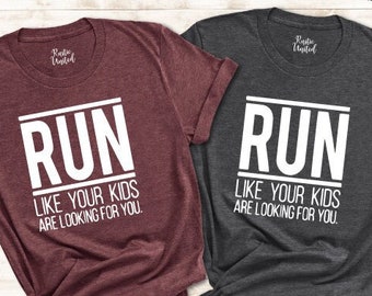 May include: Two t-shirts with the text "RUN LIKE YOUR KIDS ARE LOOKING FOR YOU." The shirts are maroon and dark gray. The text is white.