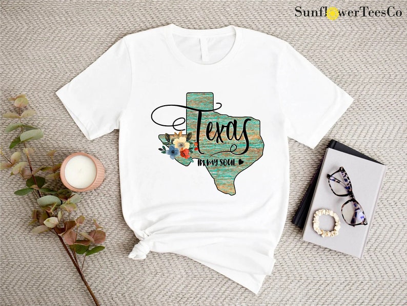 a t - shirt that says texas with flowers on it