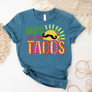 a t - shirt that says here is the tacos
