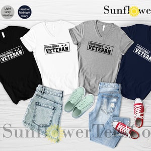 May include: Four V-neck t-shirts in black, white, heather gray, and navy blue with the text "PROUD FEMALE VETERAN" printed in white on each shirt.