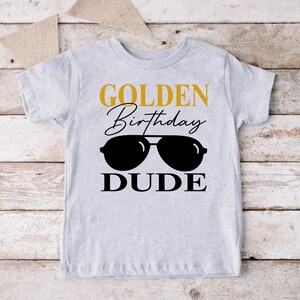 a shirt that says golden birthday dude with sunglasses on it