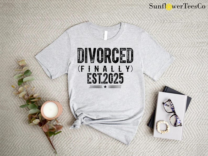 May include: Gray t-shirt with black text that reads "DIVORCED (FINALLY) EST.2025".