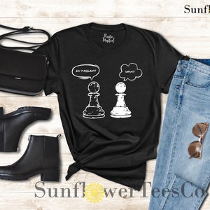 May include: Black t-shirt with a white graphic of two chess pieces. The white piece has a thought bubble above it that says "What?" and the black piece has a thought bubble above it that says "I'm pregnant?"