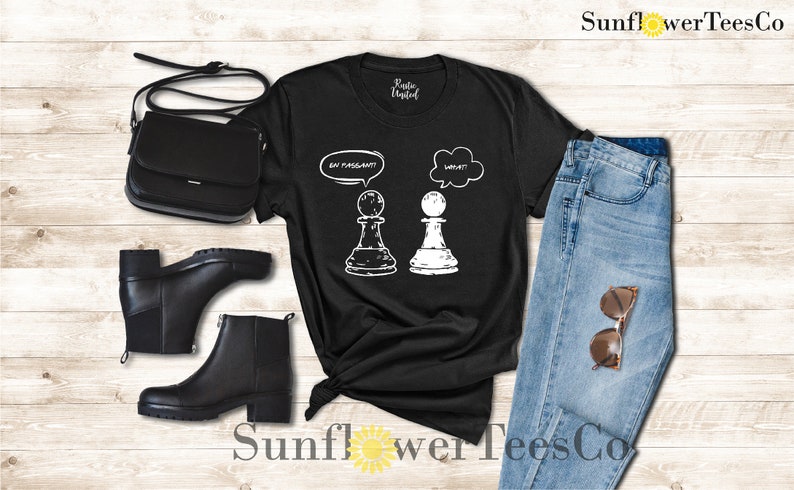 May include: Black t-shirt with a white graphic of two chess pieces. The white piece has a thought bubble above it that says "What?" and the black piece has a thought bubble above it that says "I'm pregnant?"