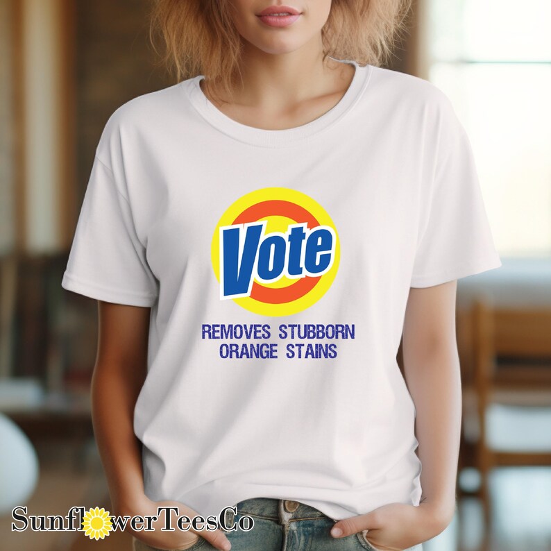 a woman wearing a vote t - shirt with the slogan, remove stubborn orange stains