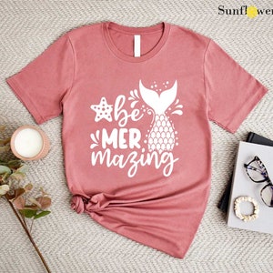 a t - shirt with a pineapple on it next to a pair of sunglasses