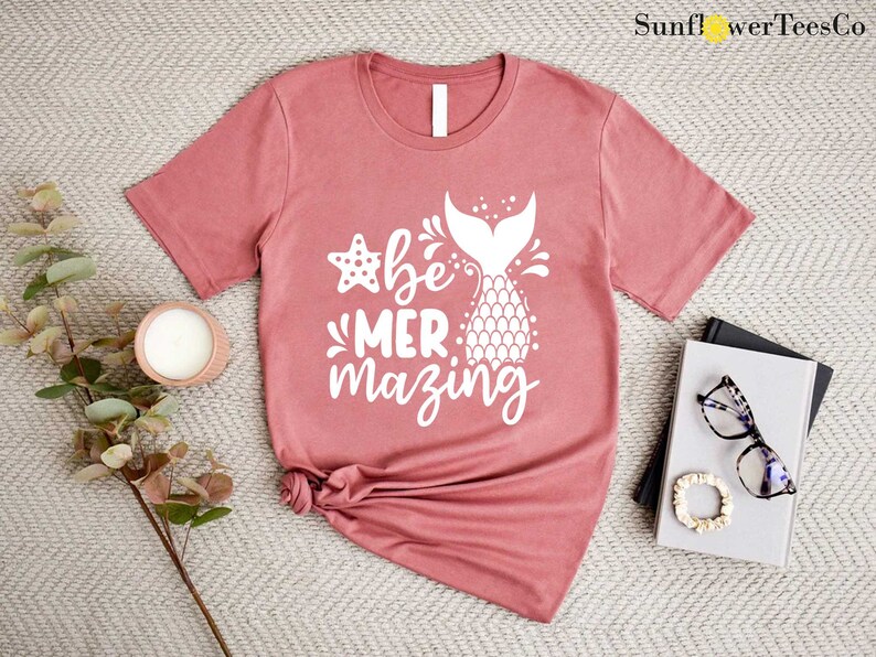 a t - shirt with a pineapple on it next to a pair of sunglasses