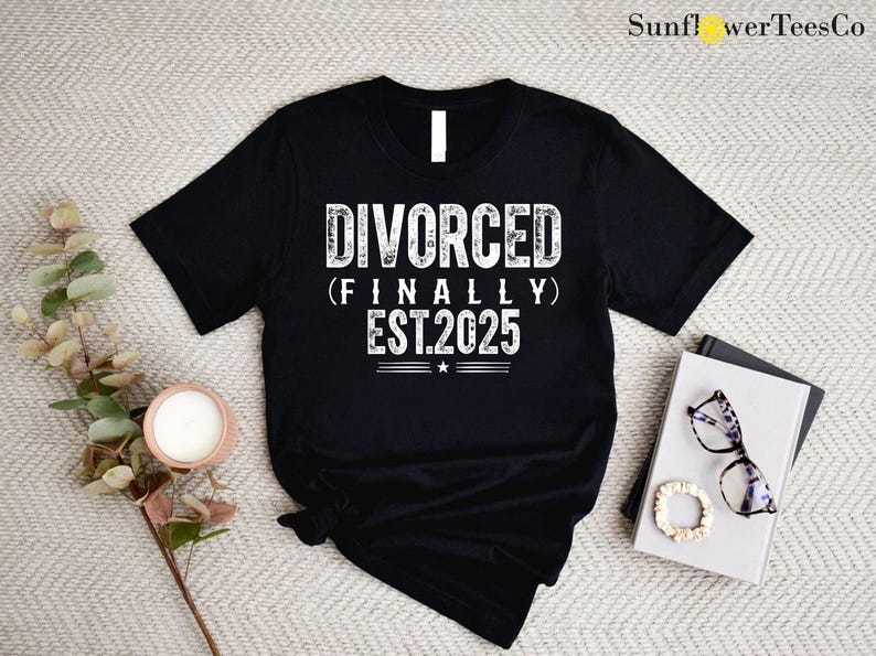 May include: Black t-shirt with white text that reads "DIVORCED (FINALLY) EST.2025".