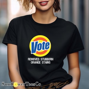 a woman wearing a black vote t - shirt