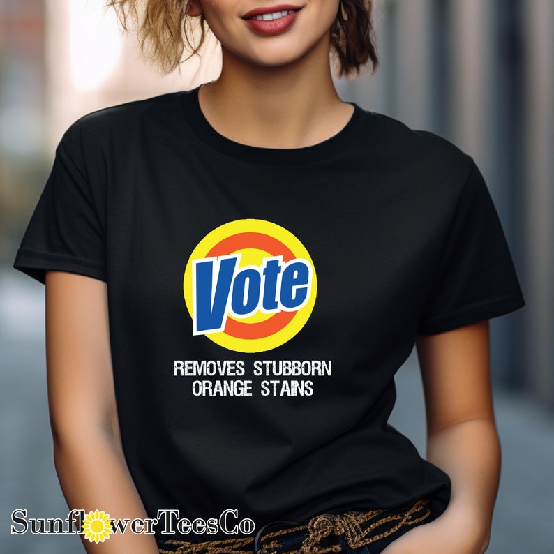 a woman wearing a black vote t - shirt