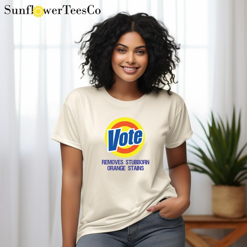 a woman wearing a white vote t - shirt
