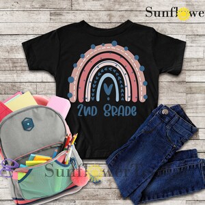 May include: Black t-shirt with a rainbow design and the text "2nd Grade".