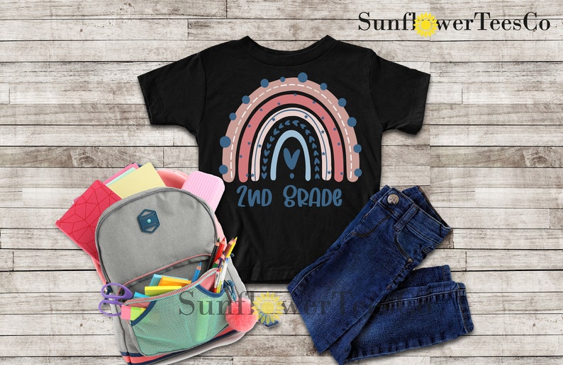 May include: Black t-shirt with a rainbow design and the text "2nd Grade".