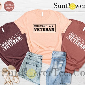 May include: Three t-shirts with the text "PROUD FEMALE VETERAN" in a white rectangle with three stars. The shirts are in maroon, peach, and heather mauve.