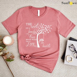 a t - shirt with a tree on it next to a pair of glasses