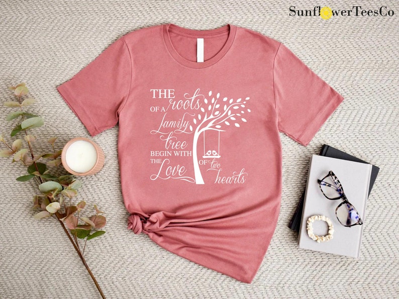 a t - shirt with a tree on it next to a pair of glasses