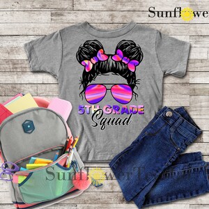 May include: Gray t-shirt with a graphic of a girl with pigtails wearing sunglasses and the text "5th Grade Squad".