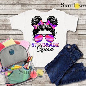 May include: White t-shirt with a graphic of a girl with pigtails wearing sunglasses and the text "5th Grade Squad".