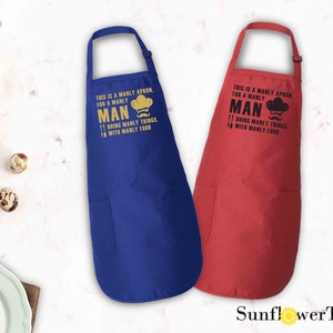 May include: Two aprons, one blue and one red, with the text "This is a manly apron, for a manly man doing manly things, with manly food" printed on them.