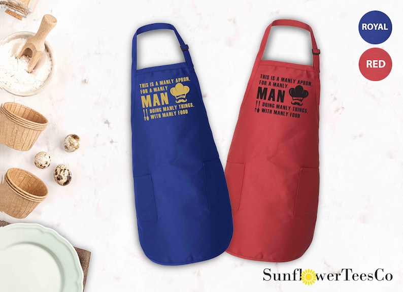 May include: Two aprons, one blue and one red, with the text "This is a manly apron, for a manly man doing manly things, with manly food" printed on them.