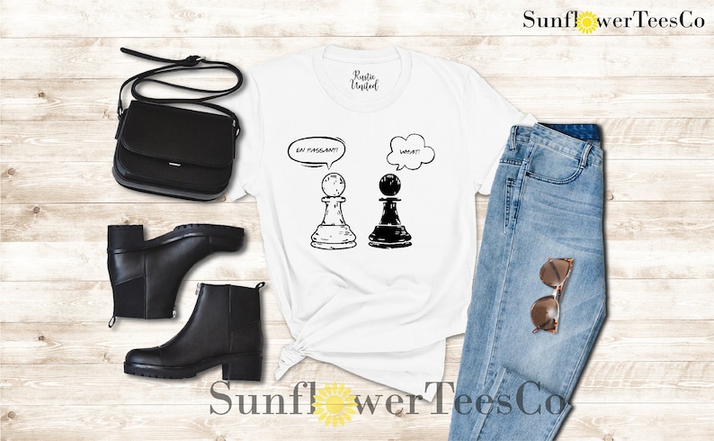 May include: White t-shirt with a black and white chess piece graphic and the text "Eat, Pray, Slay!" and "What?" in speech bubbles.