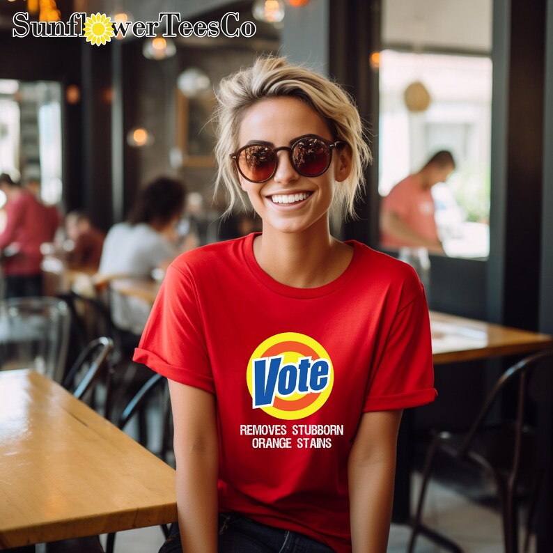 a woman wearing a vote t - shirt in a restaurant