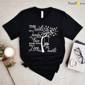 a t - shirt with a tree on it next to a pair of sunglasses