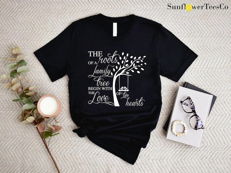 a t - shirt with a tree on it next to a pair of sunglasses