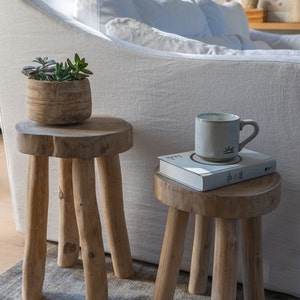 Two teak stools, with coffee mug and honey pot