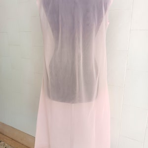 May include: A long, pink, sheer nightgown with a delicate lace trim around the neckline.
