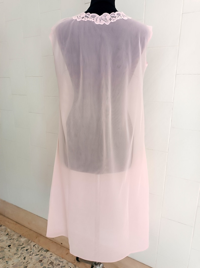 May include: A long, pink, sheer nightgown with a delicate lace trim around the neckline.