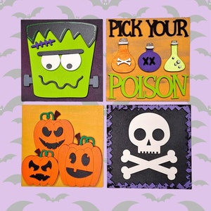 May include: Four Halloween-themed square wall decorations. The first features a green Frankenstein monster face. The second says "Pick Your Poison" with three potion bottles. The third has three orange pumpkins with black eyes and mouths. The fourth has a white skull and crossbones on a black background.