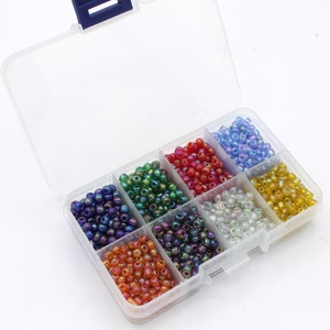 A small box of Assorted  6/0 4mm Transparent 'Rainbow' Lustre Glass Seed Beads. 8 Colours