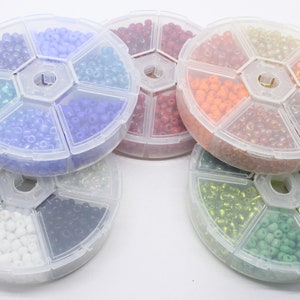 A Small box of assorted 4mm Glass Seed Beads. Approx 700 Beads