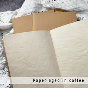 Open notebook featuring beautifully textured, coffee-dyed pages with natural stains. These unique, aged sheets are ideal for creating an authentic junk journal or rustic adventure journal.