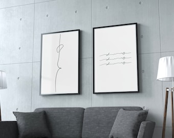 May include: Two black framed prints on a grey concrete wall. The print on the left features a simple line drawing of a person. The print on the right features three horizontal lines with circles at the end of each line.