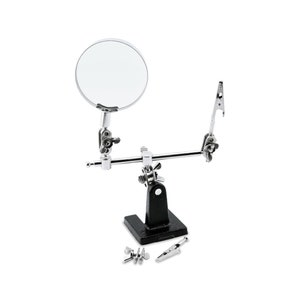 May include: A silver magnifying glass with a black stand and two adjustable clamps. The stand has a black base and the clamps are used to hold objects in place. The magnifying glass is perfect for close-up work.
